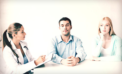 Image showing doctor with patients in cabinet