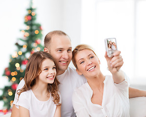 Image showing happy family with camera at home