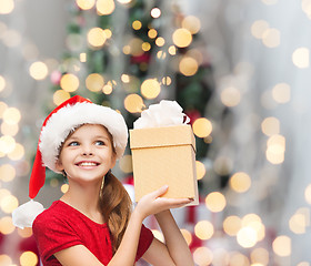 Image showing smiling girl in santa helper hat with gift box