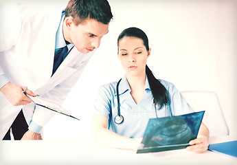 Image showing two medical workers looking at x-ray