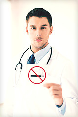 Image showing male doctor holding no smoking sign