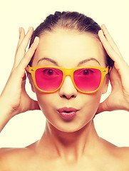 Image showing surprised teenage girl in pink sunglasses