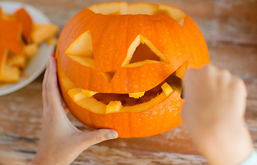 Image showing close up of woman with pumpkins at home