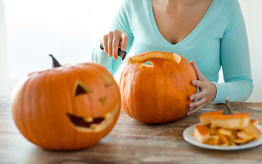 Image showing close up of woman with pumpkins at home