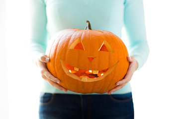 Image showing close up of woman with pumpkins at home