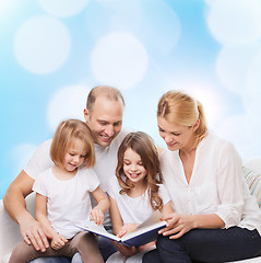 Image showing happy family with book at home