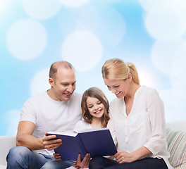 Image showing happy family with book at home