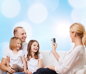 Image showing happy family with camera at home