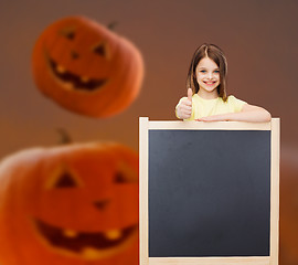 Image showing smiling little girl with blackboard