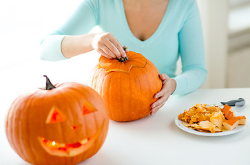 Image showing close up of woman with pumpkins at home