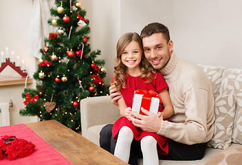 Image showing smiling father and daughter holding gift box