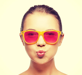 Image showing girl in pink sunglasses blowing kiss