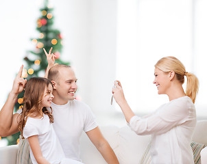 Image showing happy family with camera at home