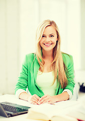 Image showing smiling student girl with laptop at school