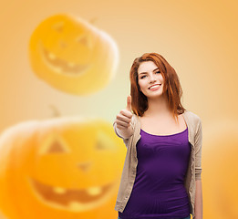 Image showing smiling teenage girl showing thumbs up