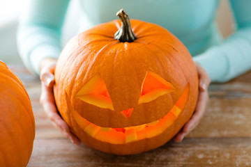 Image showing close up of woman with pumpkins at home