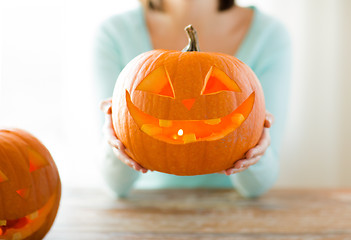 Image showing close up of woman with pumpkins at home