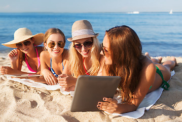 Image showing group of smiling young women with tablets on beach