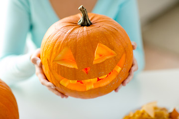 Image showing close up of woman with pumpkins at home