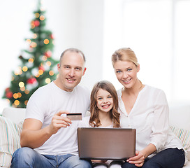 Image showing happy family with laptop computer