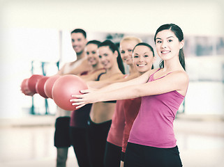 Image showing group of smiling people working out with ball