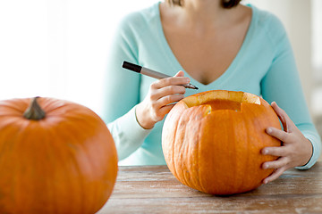 Image showing close up of woman with pumpkins at home