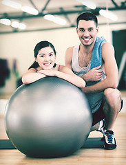 Image showing two smiling people with fitness ball