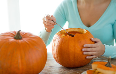 Image showing close up of woman with pumpkins at home