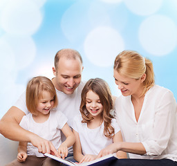 Image showing happy family with book at home