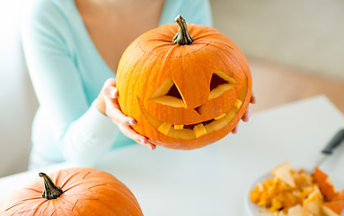 Image showing close up of woman with pumpkins at home