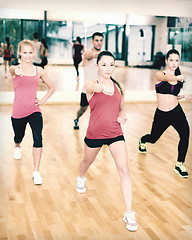 Image showing group of concentrated people exercising in the gym