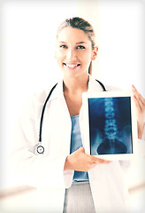 Image showing female doctor with x-ray on tablet pc