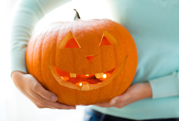 Image showing close up of woman with pumpkins at home