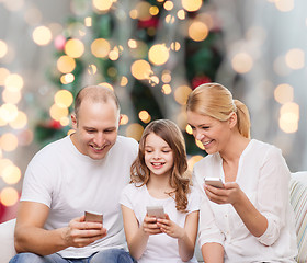 Image showing happy family with smartphones