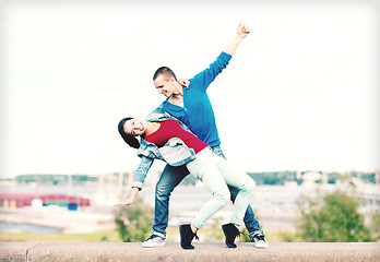 Image showing couple of teenagers dancing outside