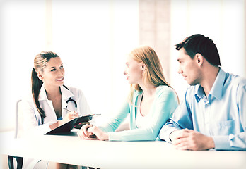 Image showing doctor with patients in cabinet