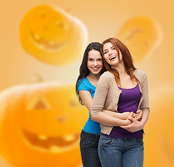 Image showing smiling teenage girls hugging