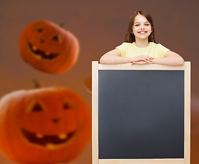 Image showing smiling little girl with blackboard