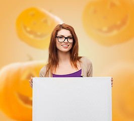 Image showing smiling teenage girl in glasses with white board