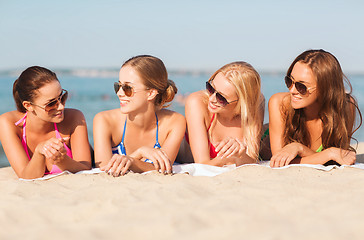 Image showing group of smiling women in sunglasses on beach