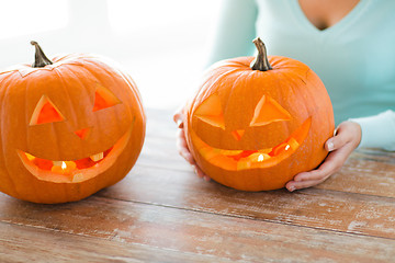 Image showing close up of woman with pumpkins at home