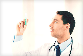 Image showing male doctor holding syringe with injection