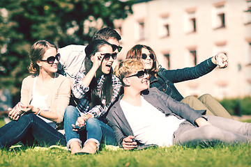 Image showing teenagers taking photo outside with smartphone