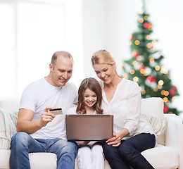 Image showing happy family with laptop computer