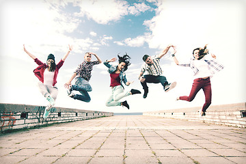 Image showing group of teenagers jumping