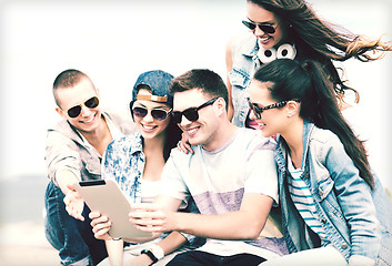Image showing group of teenagers looking at tablet pc