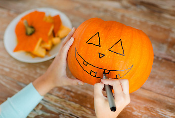 Image showing close up of woman with pumpkins at home