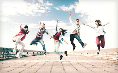 Image showing group of teenagers jumping