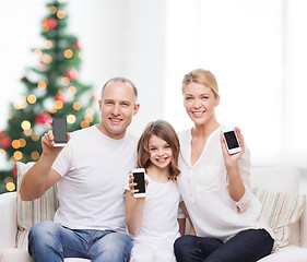 Image showing happy family with smartphones