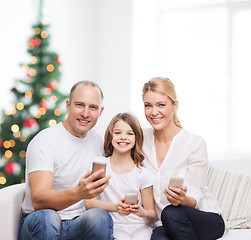 Image showing happy family with smartphones